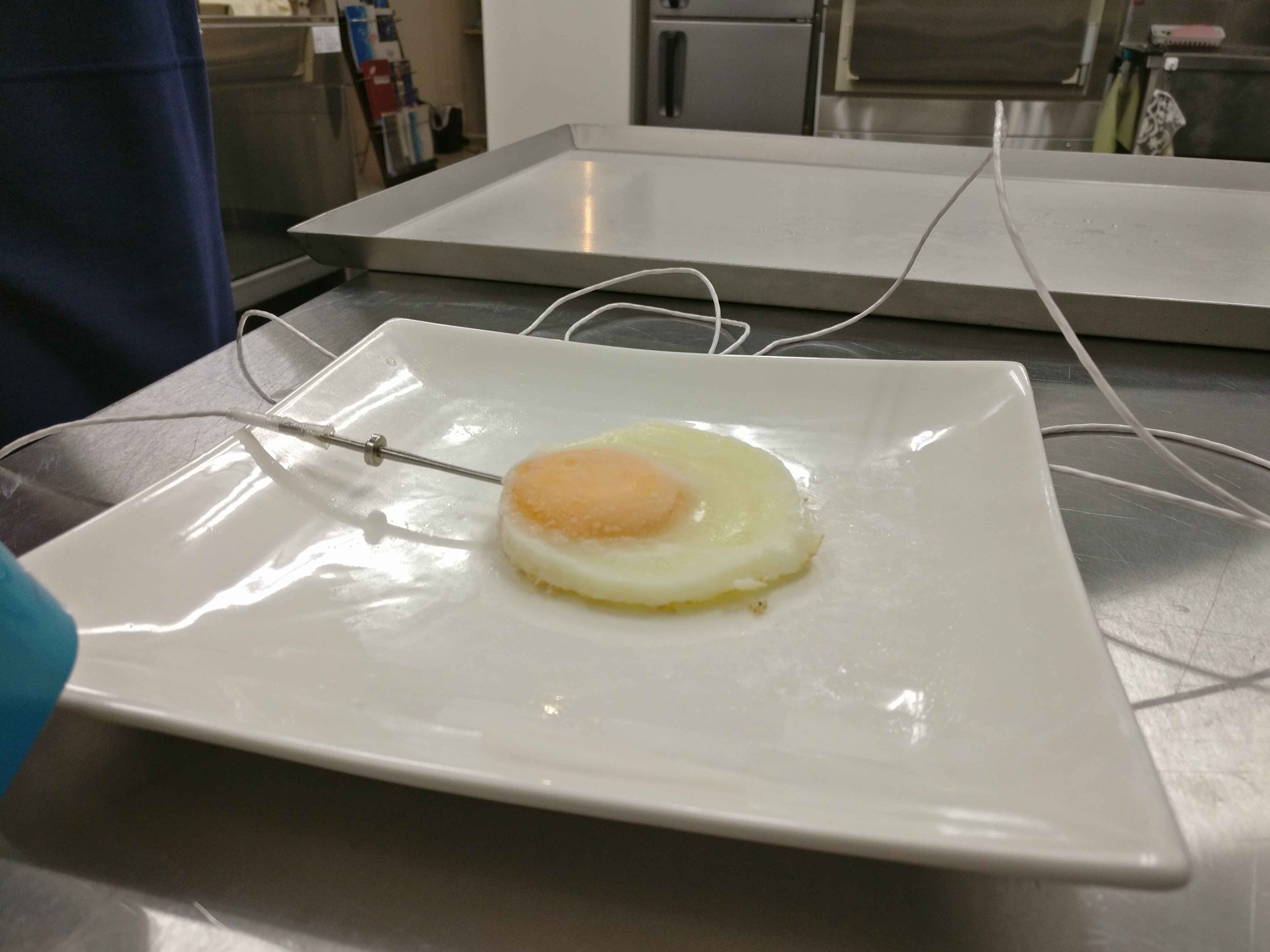 checking temperature of sunny side up egg